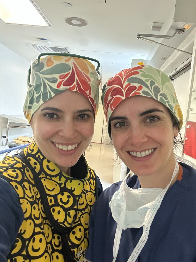 With colleague in colorful scrub caps